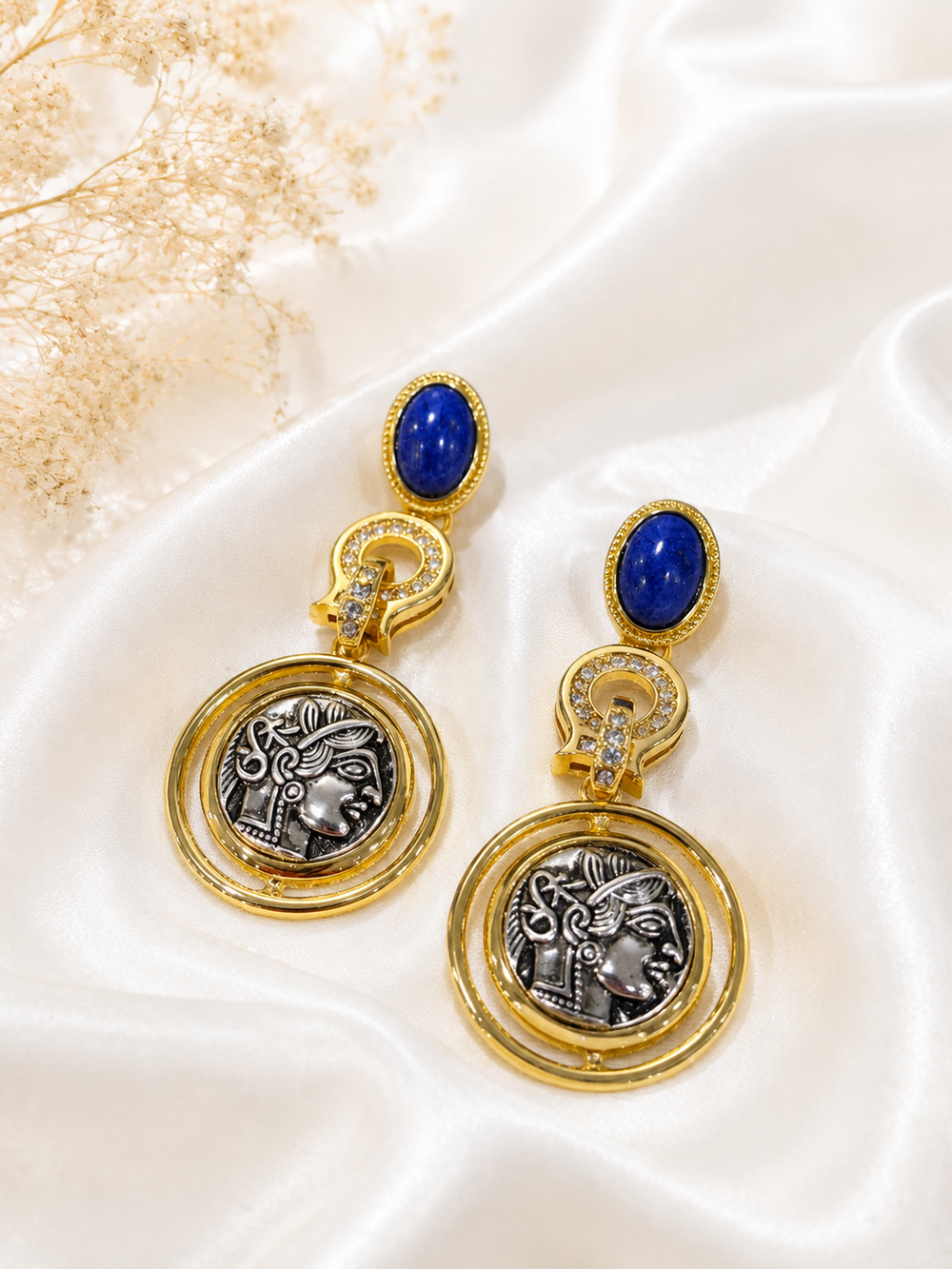 Gold-tone long coin-style blue stone drop earrings front view
