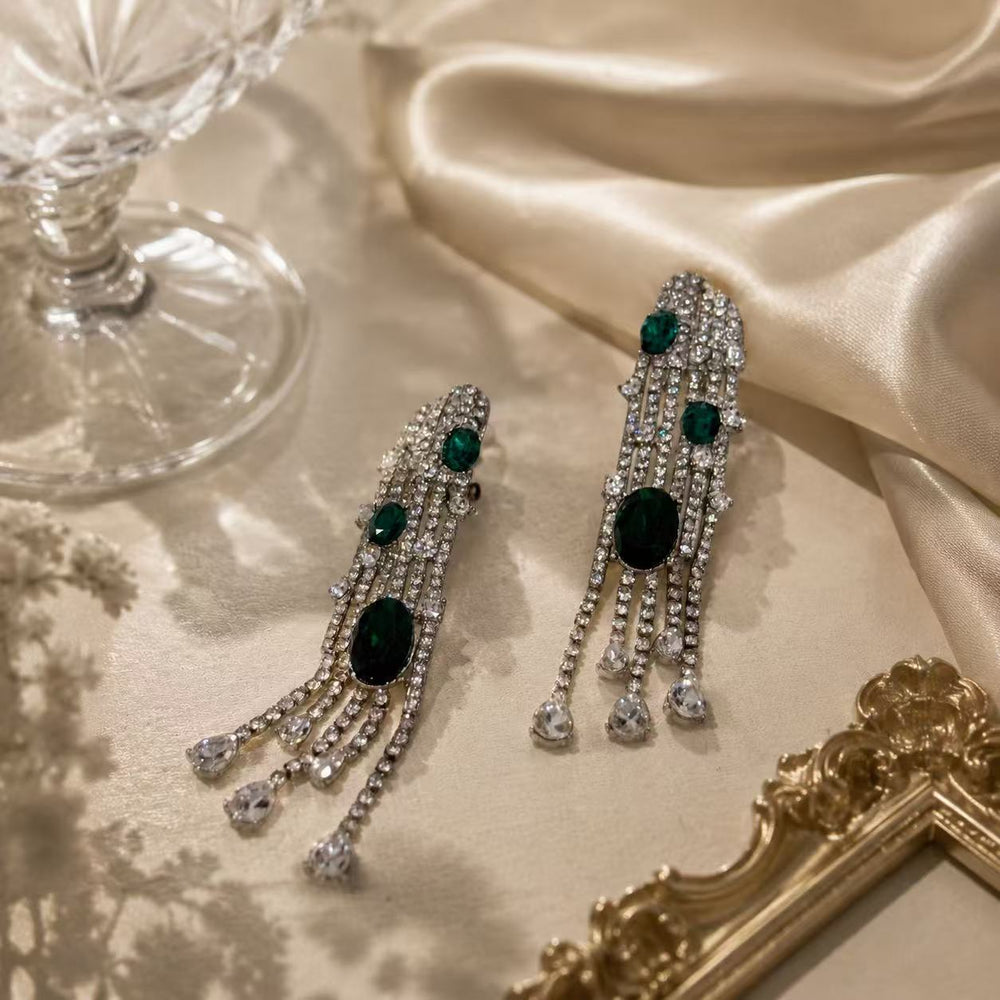 Silver-tone deep green crystal-style evening drop stud earrings detail view