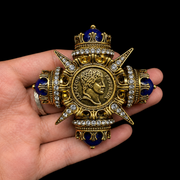 Coin-inspired brooch pendant with deep blue-style accents, detail view