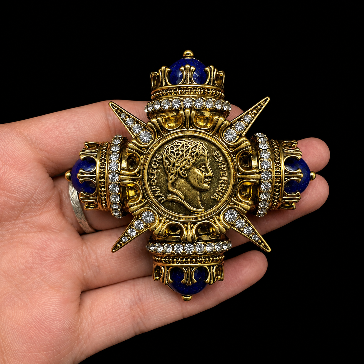 Coin-inspired brooch pendant with deep blue-style accents, detail view