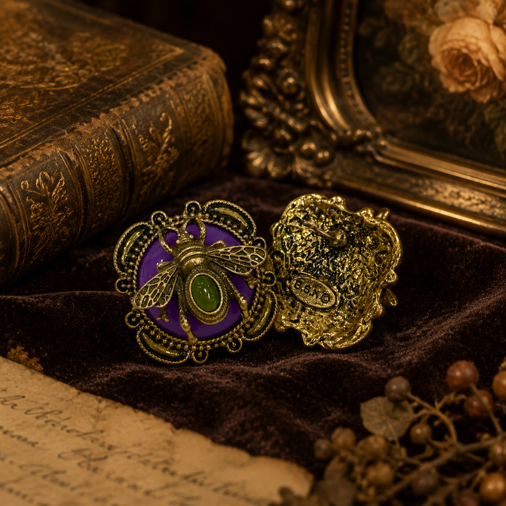 Gold-tone honey bee earring with a purple stone-style background and green cabochon-style center, front and back view