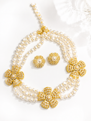 Pearl-style gold-tone flower necklace and earrings set flat lay detail view