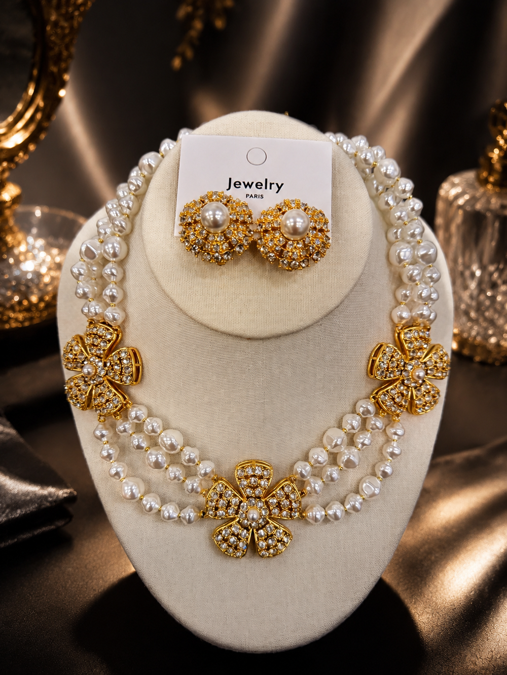 Pearl-style gold-tone flower necklace and matching earrings set front display