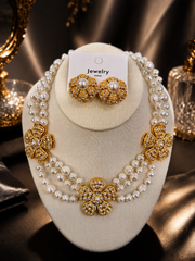 Pearl-style gold-tone flower necklace and matching earrings set front display