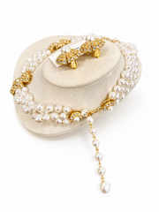 Pearl-style gold-tone flower necklace and matching earrings set side detail with clasp