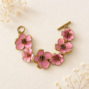 Pink enamel floral bracelet on ivory fabric