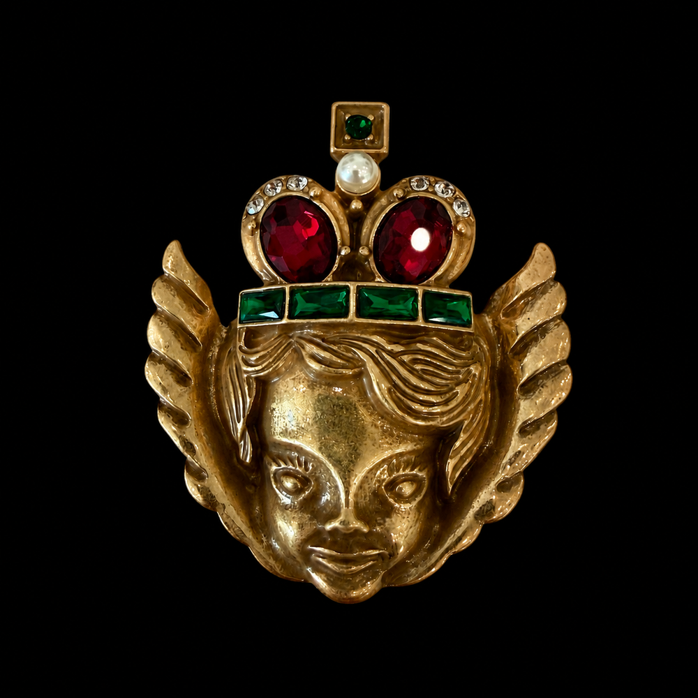 Gold-tone angel crown brooch with red and green stone-style accents front view