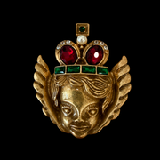 Gold-tone angel crown brooch with red and green stone-style accents front view