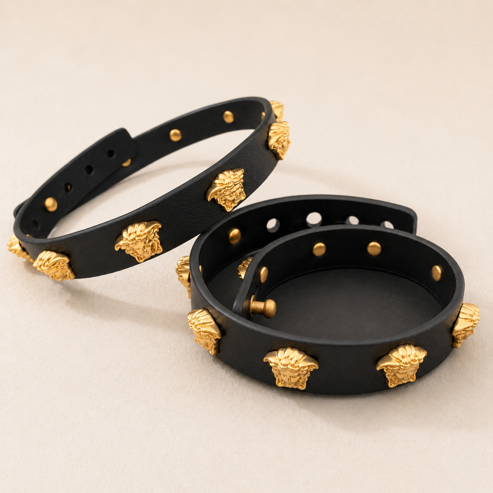 Black necklace and adjustable bracelet with gold-tone sculptural face accents