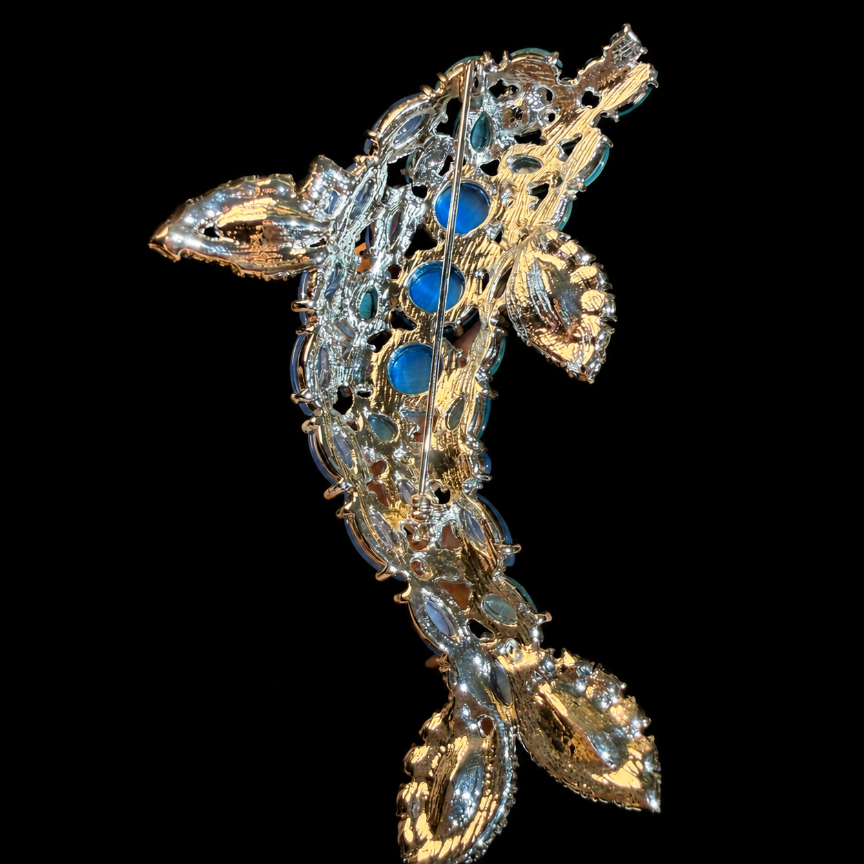Back view of silver-tone blue and aqua stone-style leaf statement brooch with pin closure