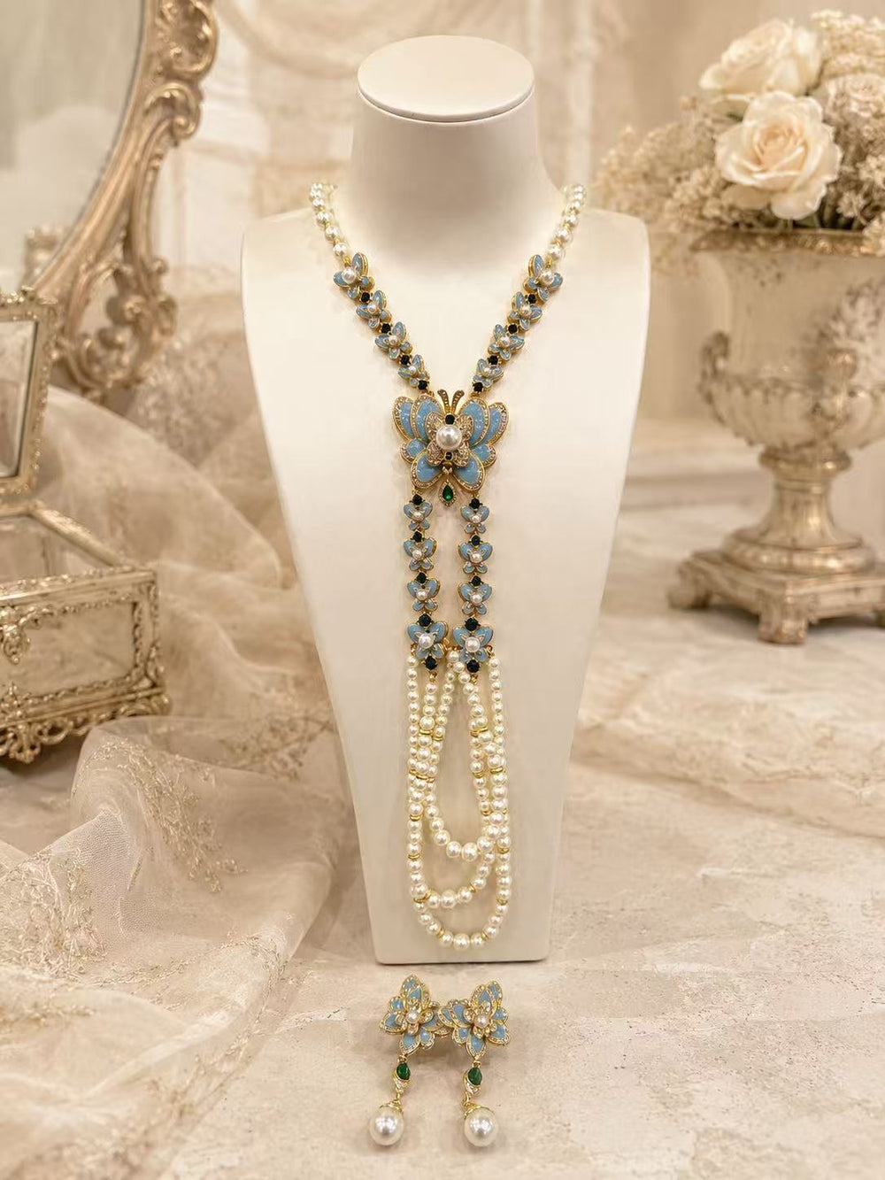 Blue butterfly enamel long necklace and stud earrings set on display
