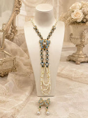 Blue butterfly enamel long necklace and stud earrings set on display