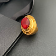 Brass ring with red oval accent on black display