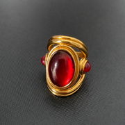 Front view of brass ring with red oval accent