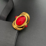Brass ring with a red oval accent on a black display