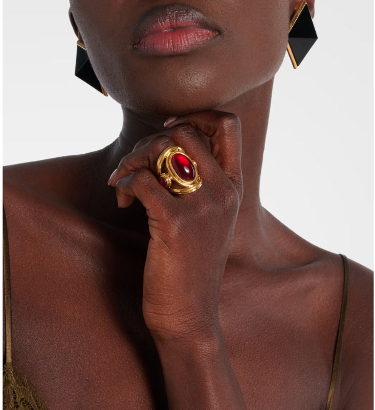 Brass ring with red oval accent worn on hand