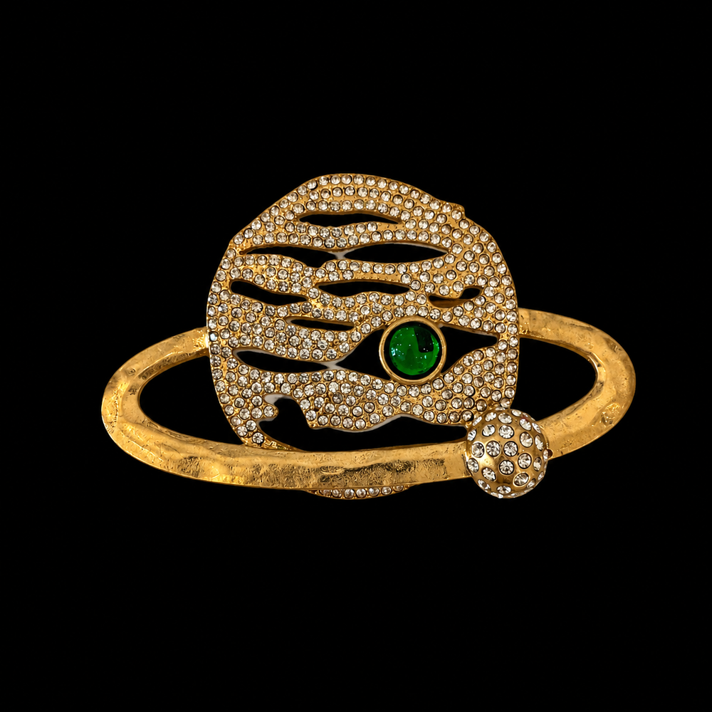 Gold-tone crystal-style face brooch with green stone-style accent front view