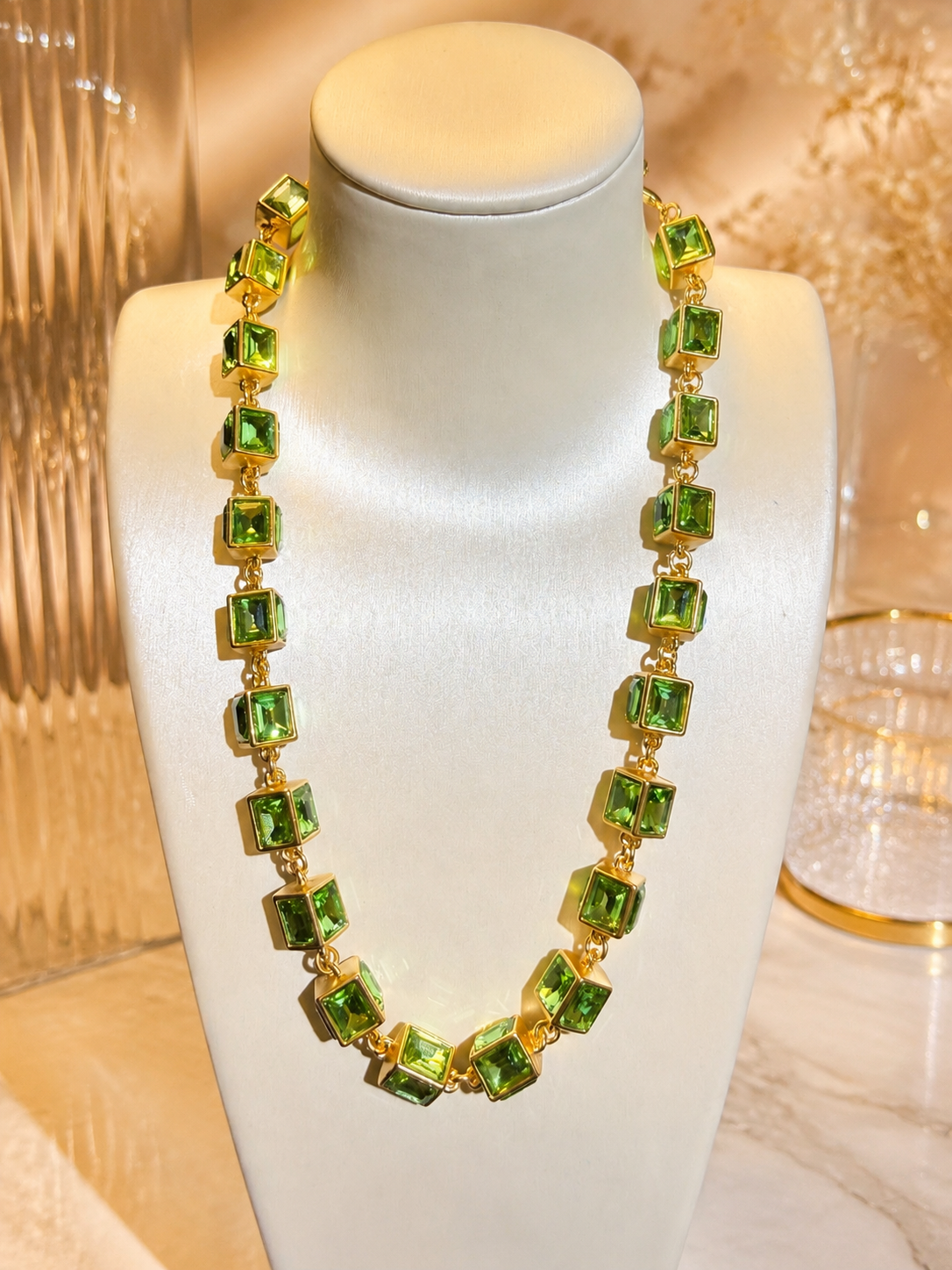 Gold-tone glass rhinestone cube link statement necklace in light green front view