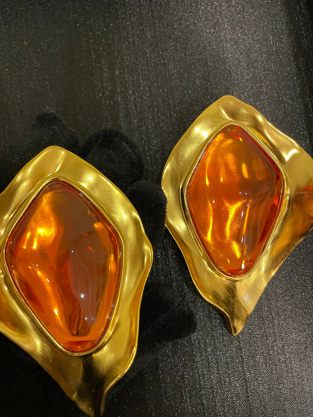 Gold-tone amber cabochon-style sculptural clip-on earrings front view