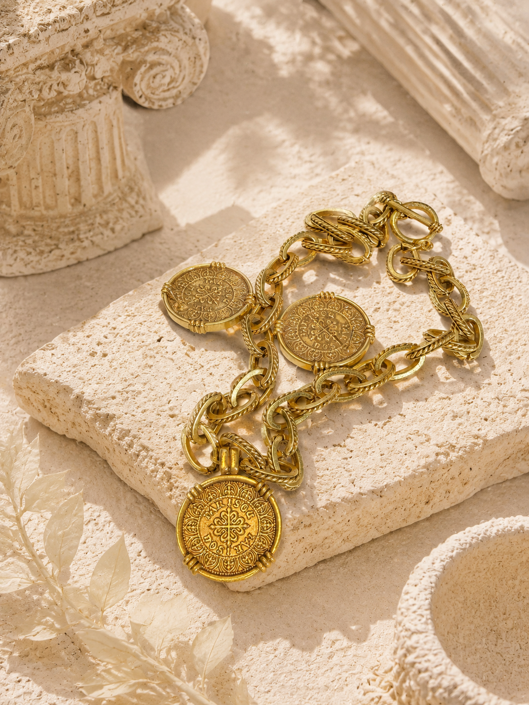 Gold-tone ancient coin-style necklace and stud earrings showing double-sided medallion detail