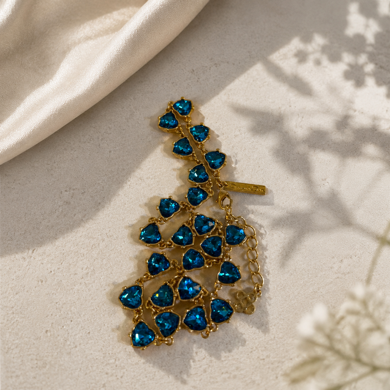Gold-tone aqua blue heart crystal-style necklace detail view