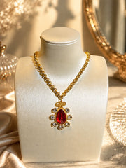 Gold-tone Barbie pink resin teardrop pendant necklace with crystal-style accents close view