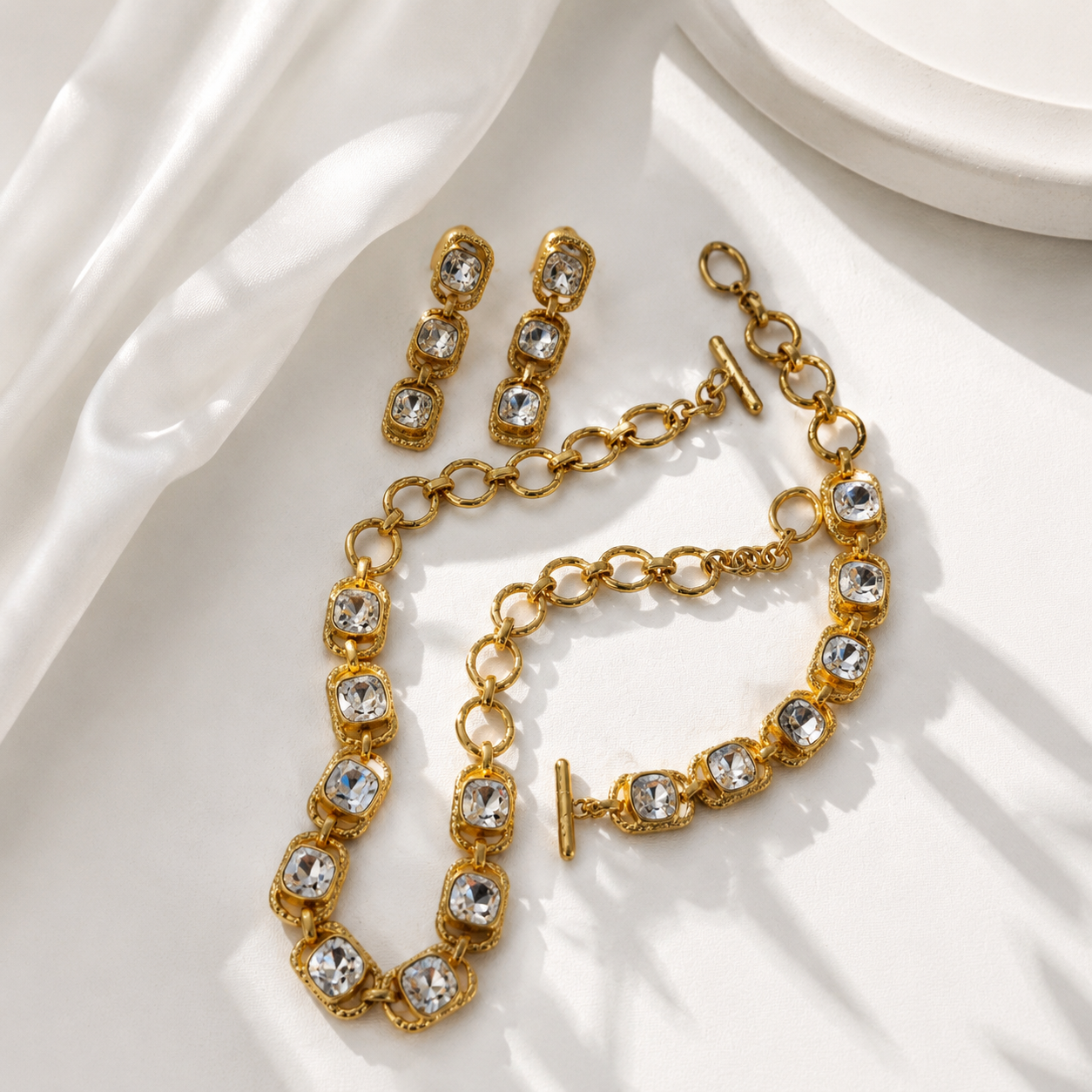 Gold-tone clear crystal-style jewelry set detail view