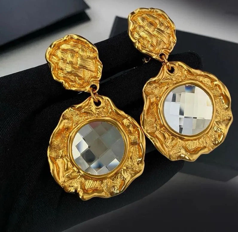 Gold-tone clear crystal-style textured medallion clip-on earrings front view
