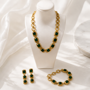 Gold-tone dark green crystal-style jewelry set with necklace bracelet and earrings display view