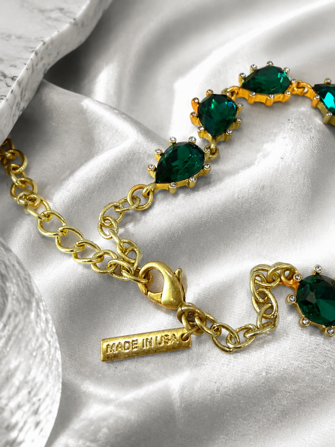 Gold-tone green rhinestone necklace clasp and extender detail