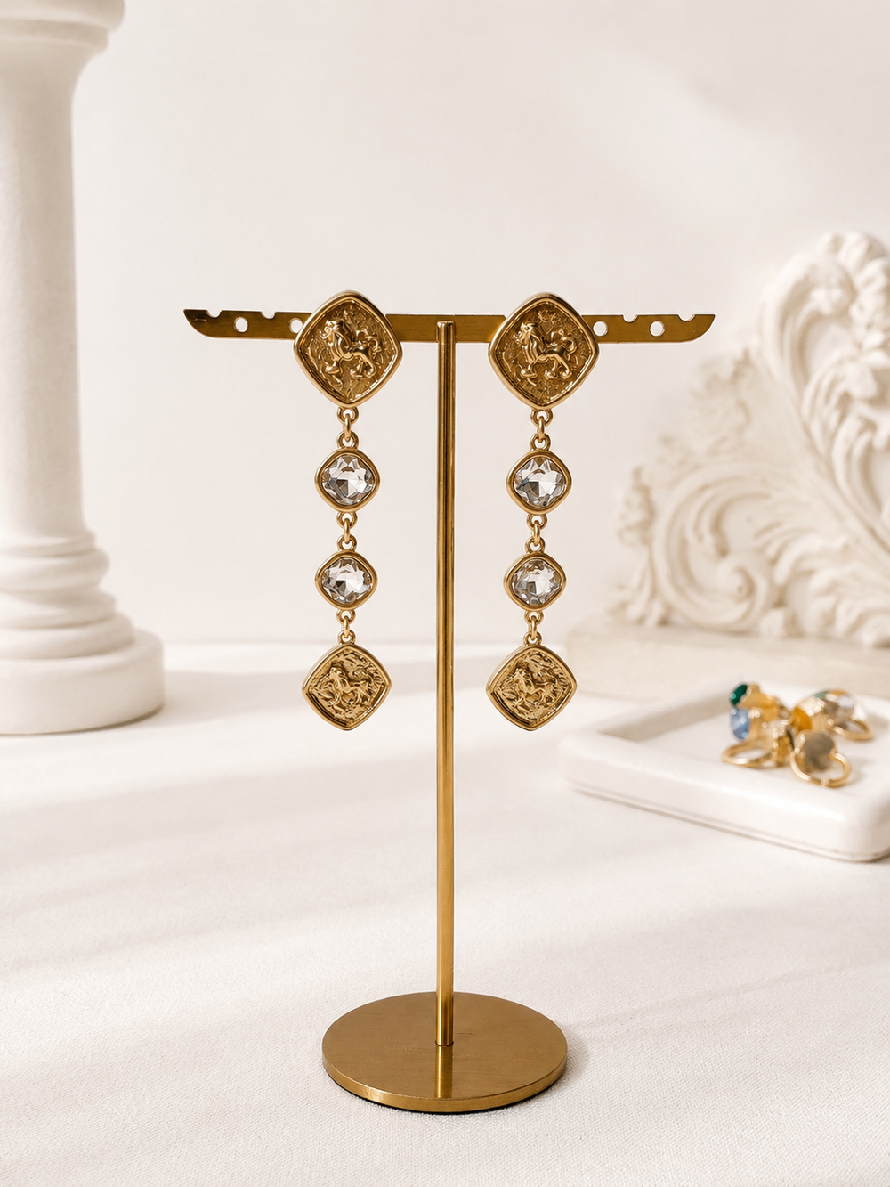Gold-tone horse medallion crystal-style drop stud earrings front display