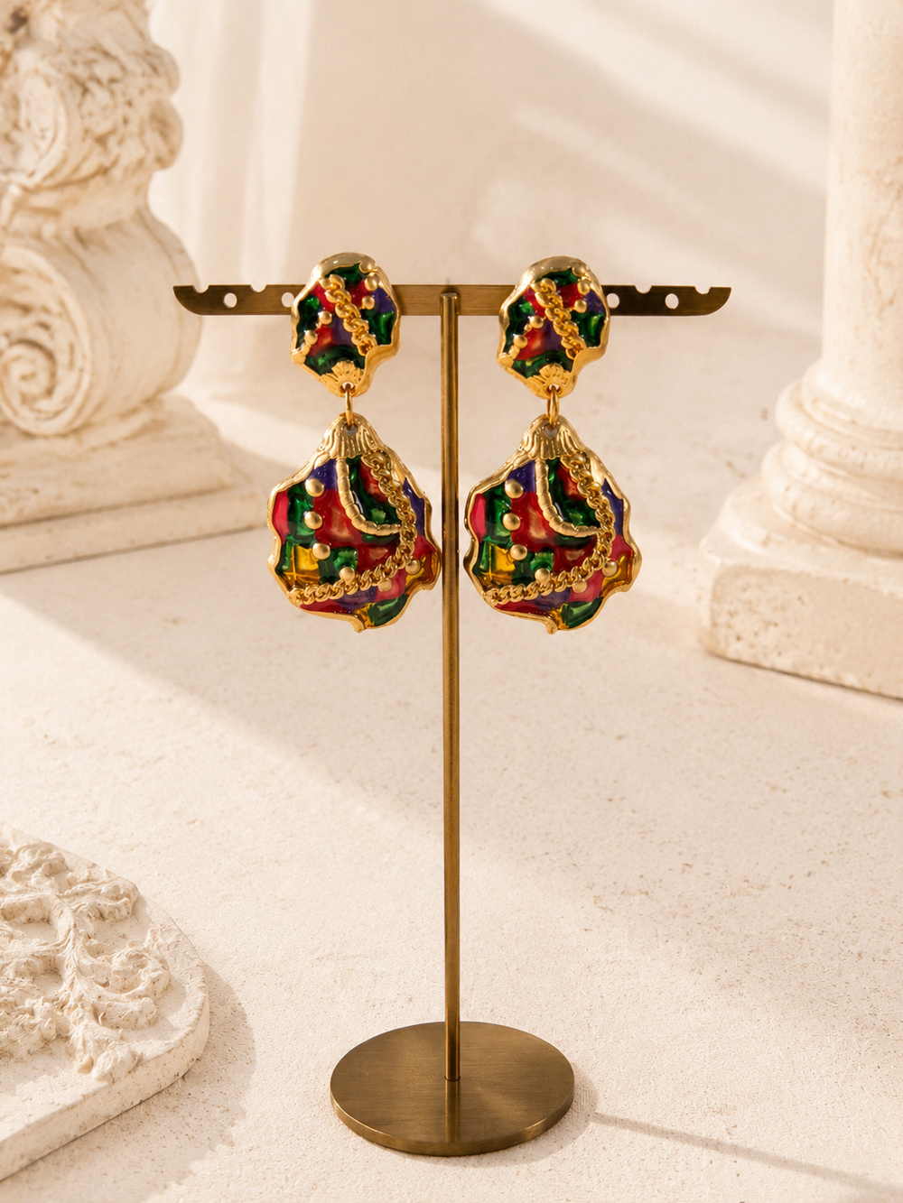 Gold-tone multicolor enamel-style drop stud earrings on display stand