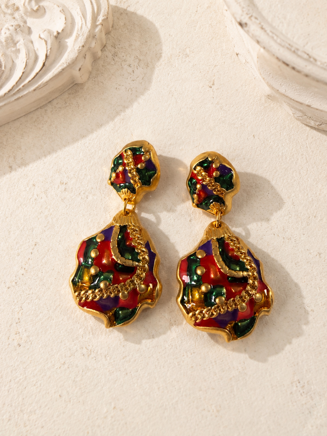 Gold-tone multicolor enamel-style drop stud earrings flat lay front view