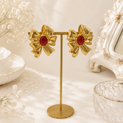Orange red gold-tone oversized bow cabochon-style stud earrings display view