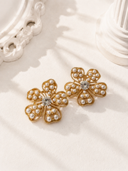 Gold-tone pearl-style flower stud earrings with clear crystal-style center