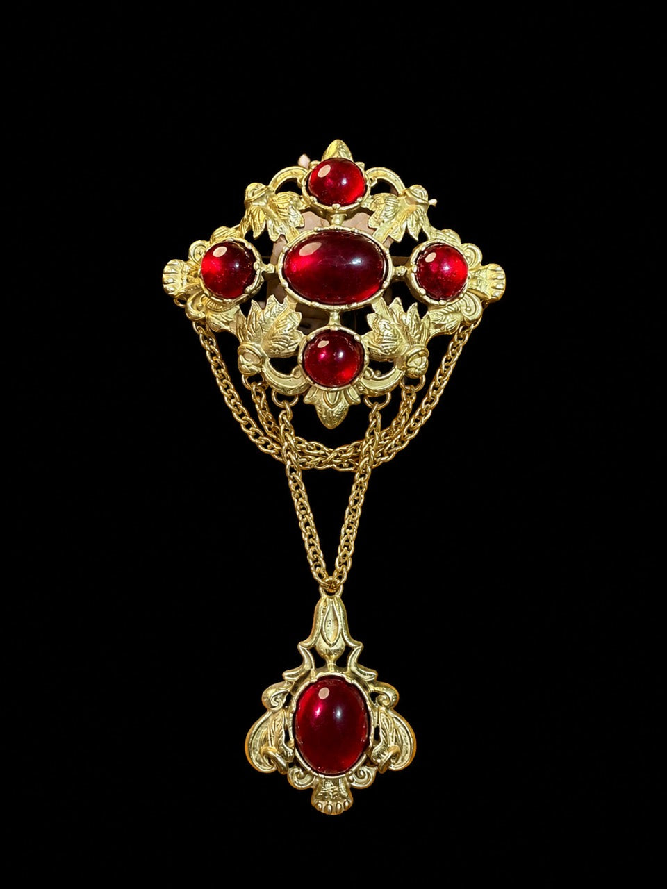 Gold-tone red glass draped chain statement brooch front view