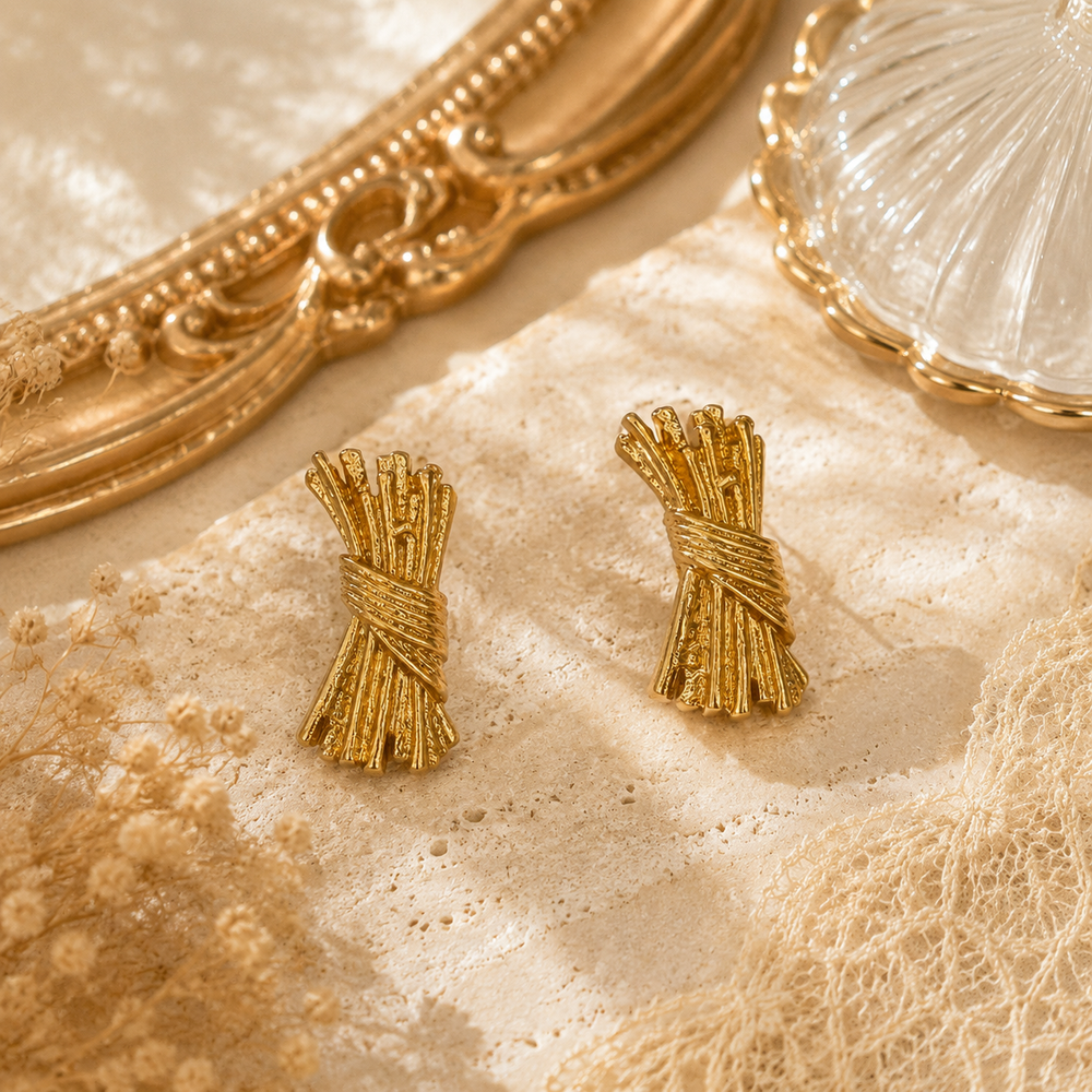 Gold-tone sculptural wrapped bundle stud earrings front view