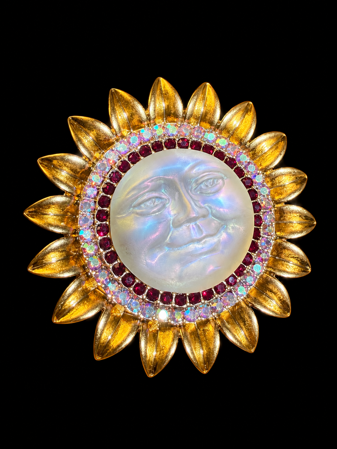 Gold-tone sun face crystal-style brooch pendant angled front view