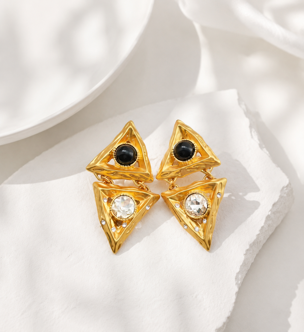 Gold-tone triangle clip-on earrings with black stone-style and clear crystal-style accents angle view
