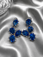 Close-up of silver-tone blue rhinestone clip-on earrings