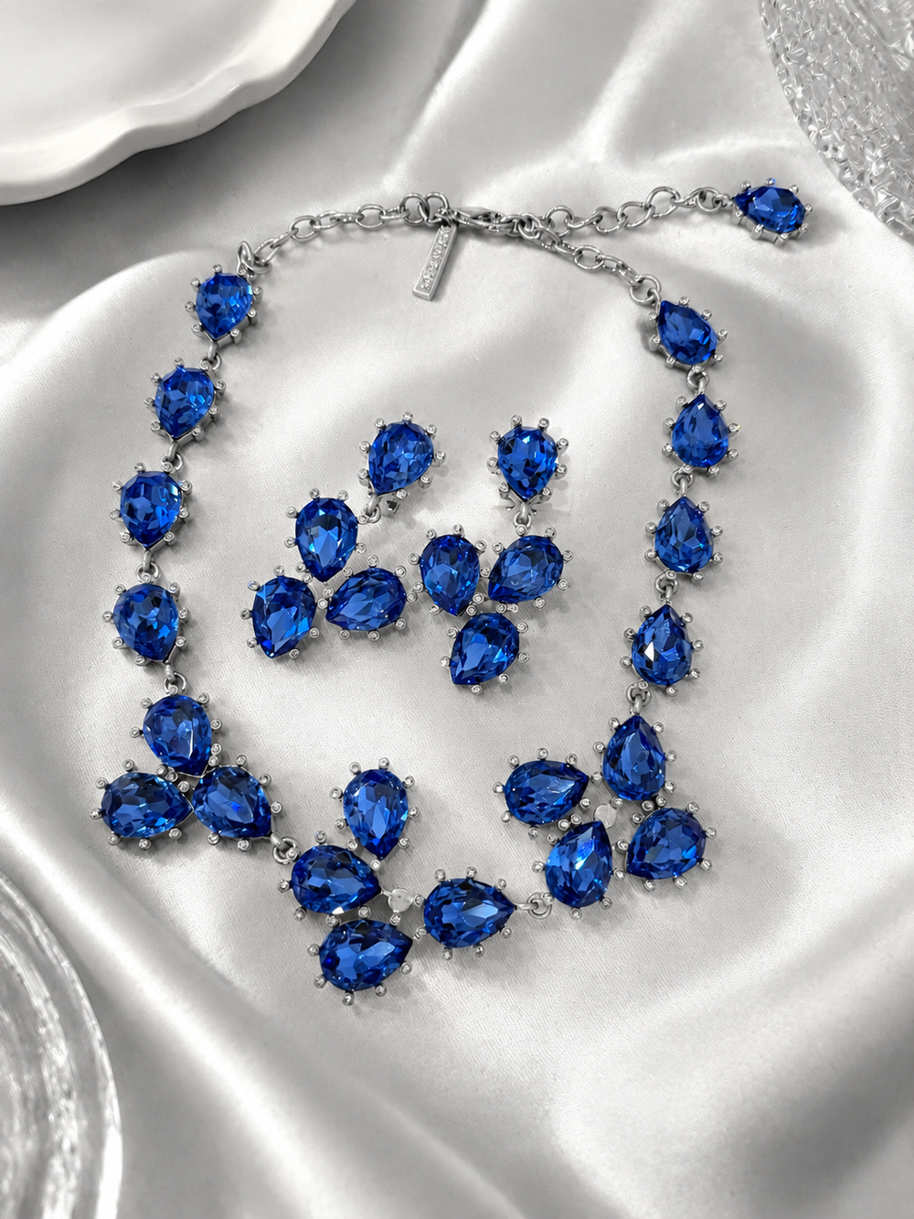 Silver-tone blue rhinestone necklace and clip-on earrings jewelry set front view