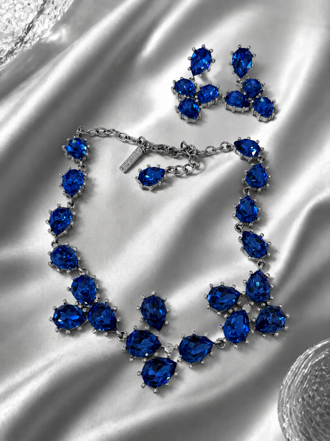 Silver-tone blue rhinestone jewelry set with matching necklace and clip-on earrings