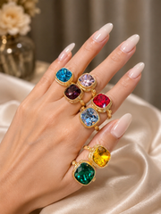 Gold-tone square statement rings shown on hand in multiple colors