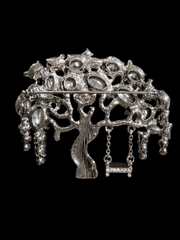 Silver-tone green rhinestone-style tree statement brooch back view with pin clasp