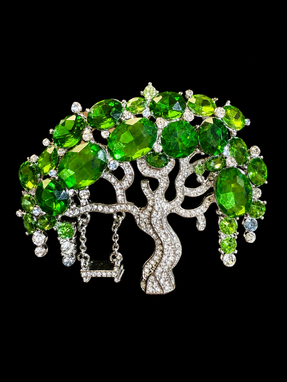 Silver-tone green rhinestone-style tree statement brooch front view
