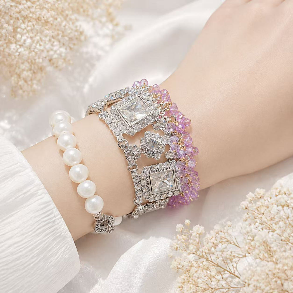 Silver-tone purple bead and crystal-style statement bracelet worn on wrist