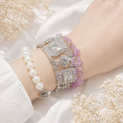Silver-tone purple bead and crystal-style statement bracelet worn on wrist