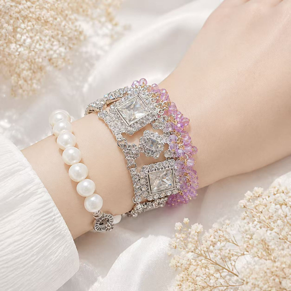Silver-tone purple bead and crystal-style statement bracelet worn on wrist