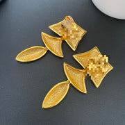 Textured gold-tone geometric clip-on drop earrings, back view