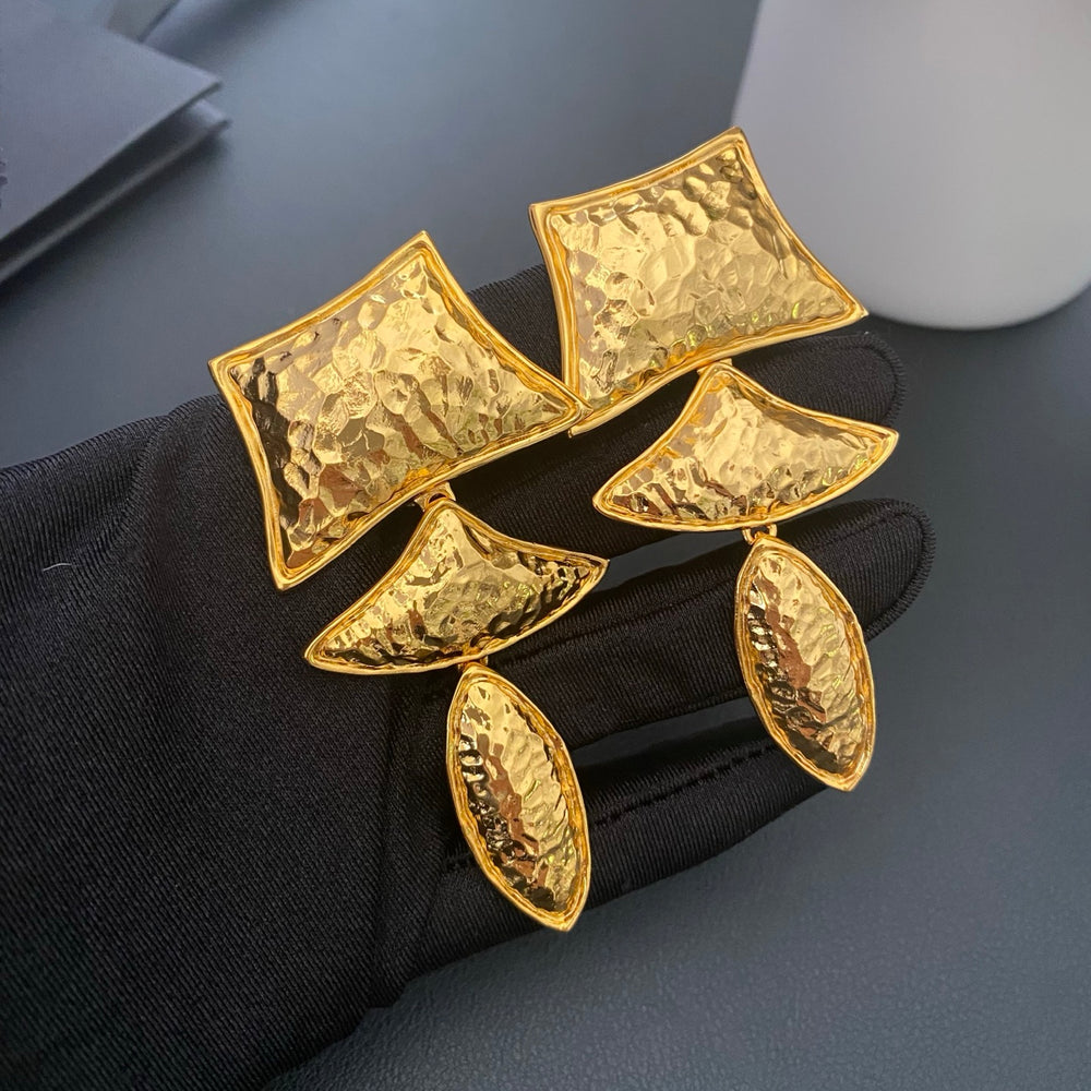 Textured gold-tone geometric clip-on drop earrings, front view
